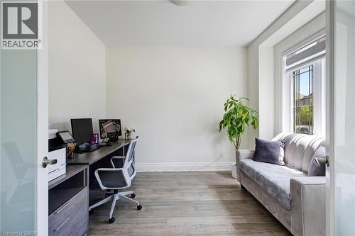 Bright room featuring wood-finish flooring and a white color palette - 57 Hollybrook Trail, Kitchener, ON 
