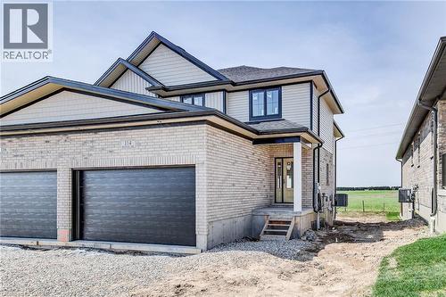 Modern build with light-toned brick facade and complementary siding - 114 Bedell Drive, Mapleton, ON - Outdoor With Exterior
