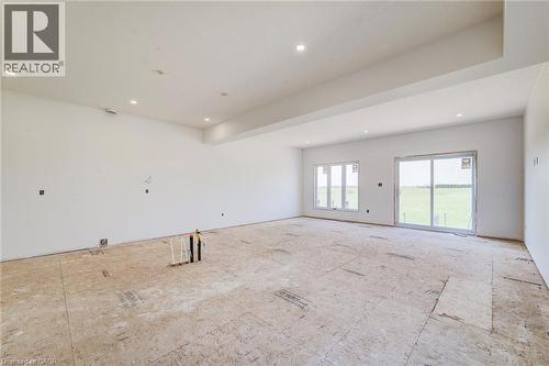 lighting and a dropped ceiling feature - 114 Bedell Drive, Mapleton, ON - Indoor Photo Showing Other Room