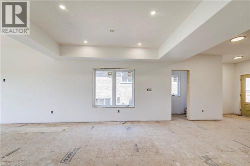 Expansive interior space featuring recessed lighting and a tray ceiling - 114 Bedell Drive, Mapleton, ON - Indoor Photo Showing Other Room