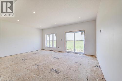 Spacious unfinished interior featuring white walls and recessed ceiling lighting - 114 Bedell Drive, Mapleton, ON - Indoor Photo Showing Other Room