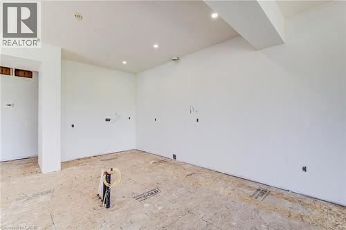 Unfinished interior space featuring light-colored walls and recessed ceiling lighting - 114 Bedell Drive, Mapleton, ON - Indoor Photo Showing Other Room