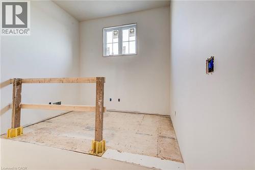 Unfinished interior space featuring a window, temporary wooden railing, and uninstalled flooring - 114 Bedell Drive, Mapleton, ON - Indoor Photo Showing Other Room