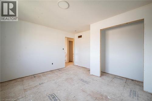 Spacious interior room featuring white painted walls and subflooring, offering an open concept for customization - 114 Bedell Drive, Mapleton, ON - Indoor Photo Showing Other Room