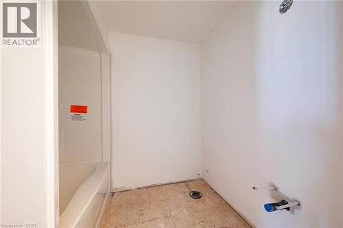 Bathroom space featuring a white acrylic bathtub and shower surround, exposed plumbing, and subfloor - 114 Bedell Drive, Mapleton, ON - Indoor Photo Showing Other Room