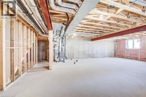 Unfinished basement featuring exposed wood framing, concrete flooring, and visible HVAC ductwork - 114 Bedell Drive, Mapleton, ON - Indoor Photo Showing Basement