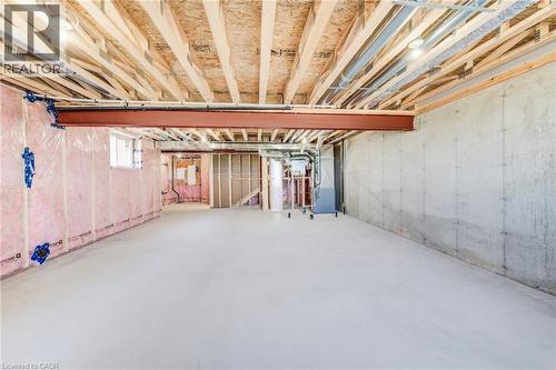 Unfinished basement featuring exposed wood joists, concrete flooring, and insulated walls - 114 Bedell Drive, Mapleton, ON - Indoor Photo Showing Basement