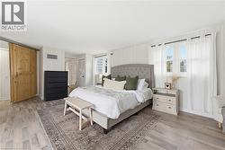 Spacious room featuring wood-finish flooring and vertical paneling - 