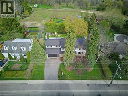 Aerial perspective showcasing a residential property with a dark shingle roof and a two-car garage - 
