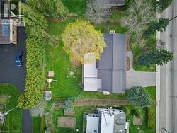Expansive property with a dark shingle roof and a concrete driveway - 