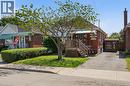 Red brick exterior with white trim details and a covered porch entry - 97 Tragina Avenue S, Hamilton, ON 