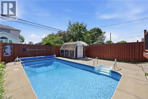 Fenced backyard featuring an in-ground swimming pool with concrete surround - 97 Tragina Avenue S, Hamilton, ON 