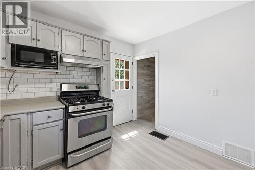 Kitchen featuring light gray cabinetry with brushed nickel hardware, a stainless steel gas range - 97 Tragina Avenue S, Hamilton, ON 
