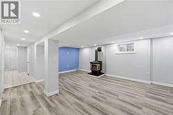 Spacious room featuring wood-finish flooring - 