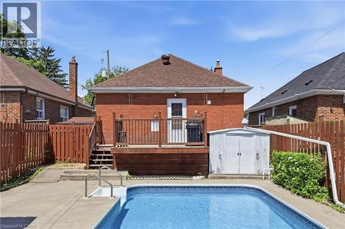 In-ground swimming pool with surrounding concrete patio - 97 Tragina Avenue S, Hamilton, ON 