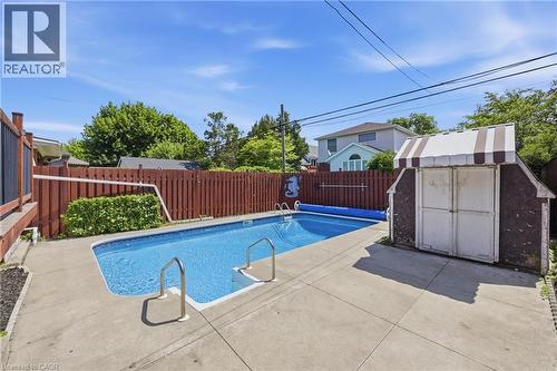 In-ground swimming pool with concrete surround - 97 Tragina Avenue S, Hamilton, ON 