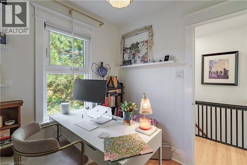 Bright room featuring a large window with white trim, white walls, and a built-in floating shelf - 41 Park Row N, Hamilton, ON 