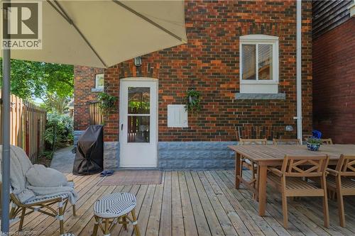 Spacious outdoor wood-finish deck with a brick exterior - 41 Park Row N, Hamilton, ON 