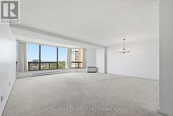 Spacious living area, flooded with natural light. - 