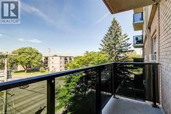 Private balcony featuring a black metal and glass railing system - 