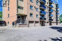 Multi-story brick building featuring multiple private balconies with glass railings - 
