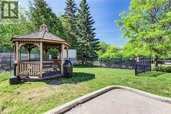 Wood gazebo with shingle roof and integrated picnic table - 