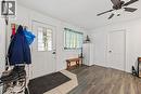 Entryway featuring a decorative glass paneled door, wood-finish flooring, and a ceiling fan with integrated lighting - 54 E Chestnut Street E, St. Catharines, ON 