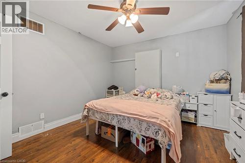 Room with wood-finish flooring, light gray walls, and white trim - 54 E Chestnut Street E, St. Catharines, ON - Indoor Photo Showing Bedroom