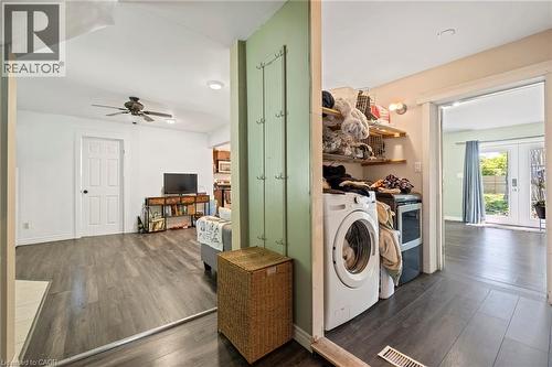 Dedicated laundry area featuring built-in shelving, washer, and dryer - 54 E Chestnut Street E, St. Catharines, ON - Indoor Photo Showing Laundry Room