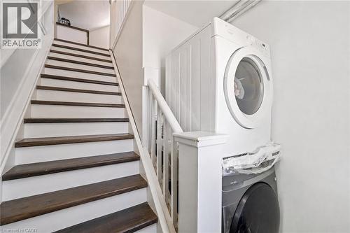 Staircase featuring dark wood treads and white risers - 54 E Chestnut Street E, St. Catharines, ON - Indoor Photo Showing Laundry Room