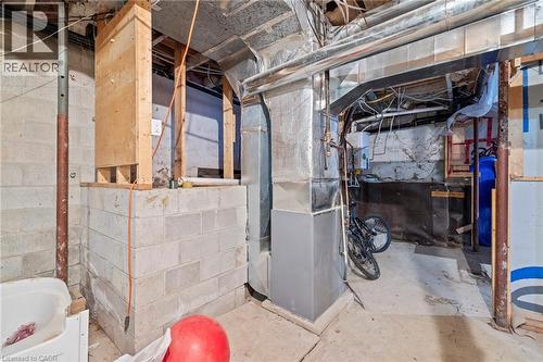 Unfinished basement area featuring concrete block walls and exposed ductwork - 54 E Chestnut Street E, St. Catharines, ON - Indoor Photo Showing Basement