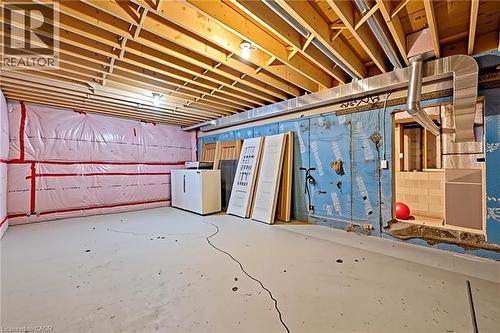 Unfinished basement space featuring exposed wood joists, insulated exterior walls, concrete flooring, and visible ductwork - 54 E Chestnut Street E, St. Catharines, ON - Indoor Photo Showing Basement