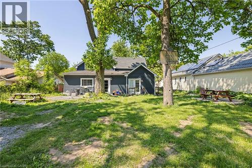Rear exterior featuring dark siding, white trim, and a glass-paneled door - 54 E Chestnut Street E, St. Catharines, ON - Outdoor