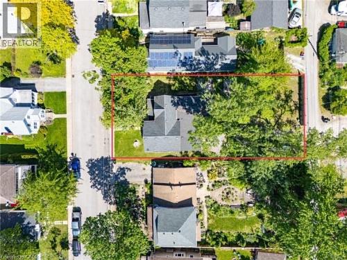 Aerial perspective showcasing a residential property with a multi-story home, a paved driveway, and extensive mature trees - 54 E Chestnut Street E, St. Catharines, ON - Outdoor With View