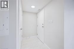 Corridor featuring electric panel and light tile patterned floors - 