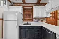 Compact kitchen featuring an L-shaped countertop with a stainless steel sink - 
