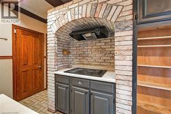 Brick archway feature with an integrated electric cooktop and range hood - 
