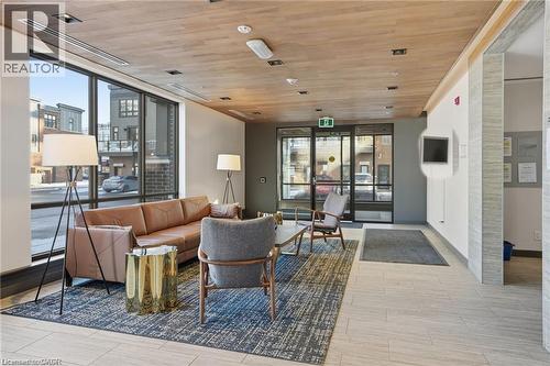 Lobby area featuring large storefront windows, wood-finish ceiling, recessed lighting, and light-toned tile flooring - 40 Esplanade Lane Unit# 614, Grimsby, ON 