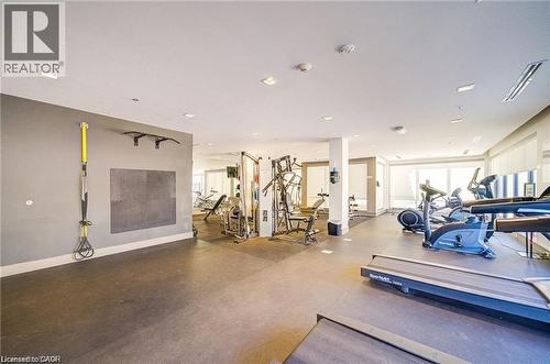 Dedicated fitness area featuring rubberized flooring, abundant natural light, integrated wall-mounted exercise equipment, recessed ceiling lighting, and a variety of cardio and strength training machi - 40 Esplanade Lane Unit# 614, Grimsby, ON 