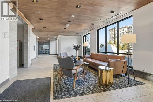 Lobby area featuring wood-finish ceiling panels, recessed lighting, and large windows - 40 Esplanade Lane Unit# 614, Grimsby, ON 