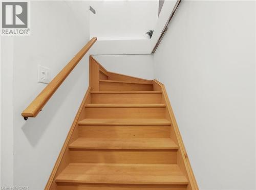 Staircase with wood-finish treads and risers, complemented by a solid wood handrail - 420 Waverly Street, Hamilton, ON 