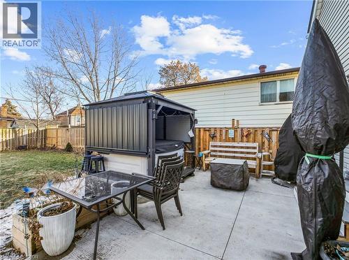Concrete patio area featuring a covered hot tub structure - 420 Waverly Street, Hamilton, ON 