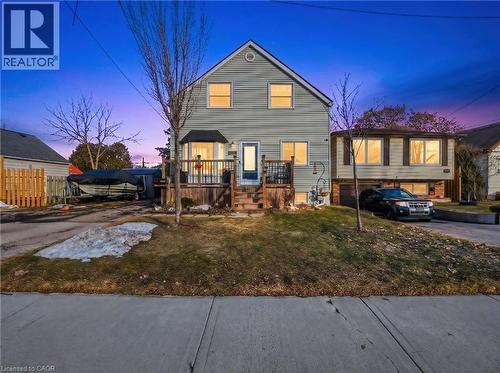 Light-colored siding exterior with a prominent bay window and an elevated front porch - 420 Waverly Street, Hamilton, ON 
