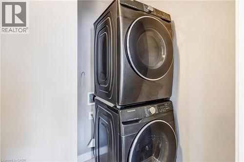 Stacked washer and dryer unit with dark finishes - 417 Rivertrail Avenue, Kitchener, ON 