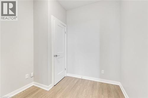 Room featuring light wood-finish flooring, white baseboards, and neutral wall tones - 657 Barton Street E Unit# 302, Hamilton, ON 