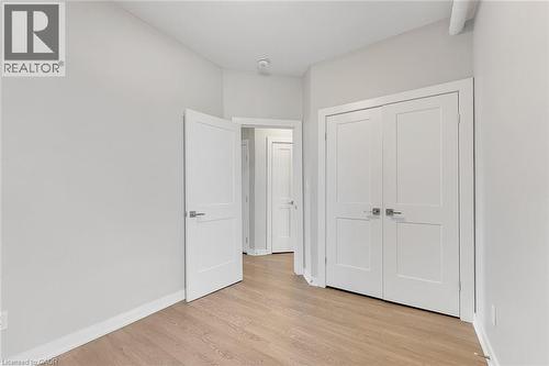 Interior room featuring light wood-finish flooring and light gray walls - 657 Barton Street E Unit# 302, Hamilton, ON 