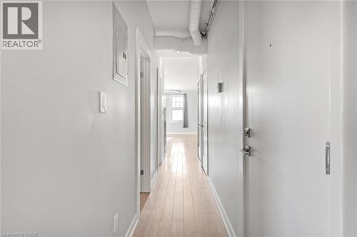 Hardwood-finish flooring extending through the hallway - 657 Barton Street E Unit# 302, Hamilton, ON 