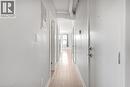 Hardwood-finish flooring extending through the hallway - 657 Barton Street E Unit# 302, Hamilton, ON 