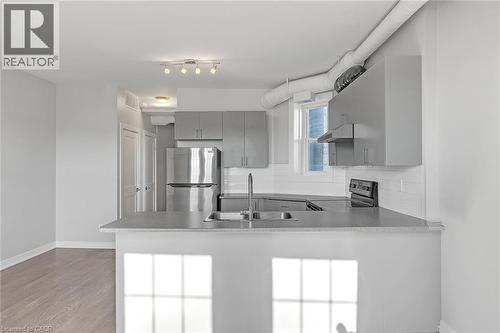 Contemporary kitchen with gray cabinetry and stainless steel appliances - 657 Barton Street E Unit# 302, Hamilton, ON 