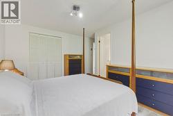 Bright bedroom featuring white walls and a carpeted floor - 